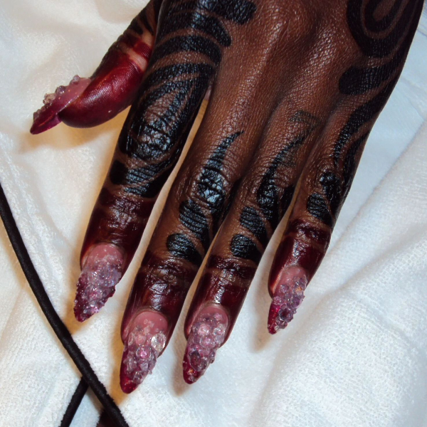 A closeup of Doechi's red and pink Met Gala 2026 manicure.