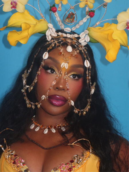 A close up of SZA's makeup and yellow floral headdress for the 2026 Met Gala.
